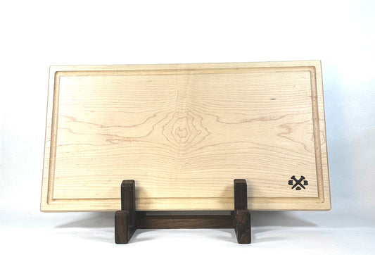 Wooden cutting board on a stand with a visible brand logo against a white background