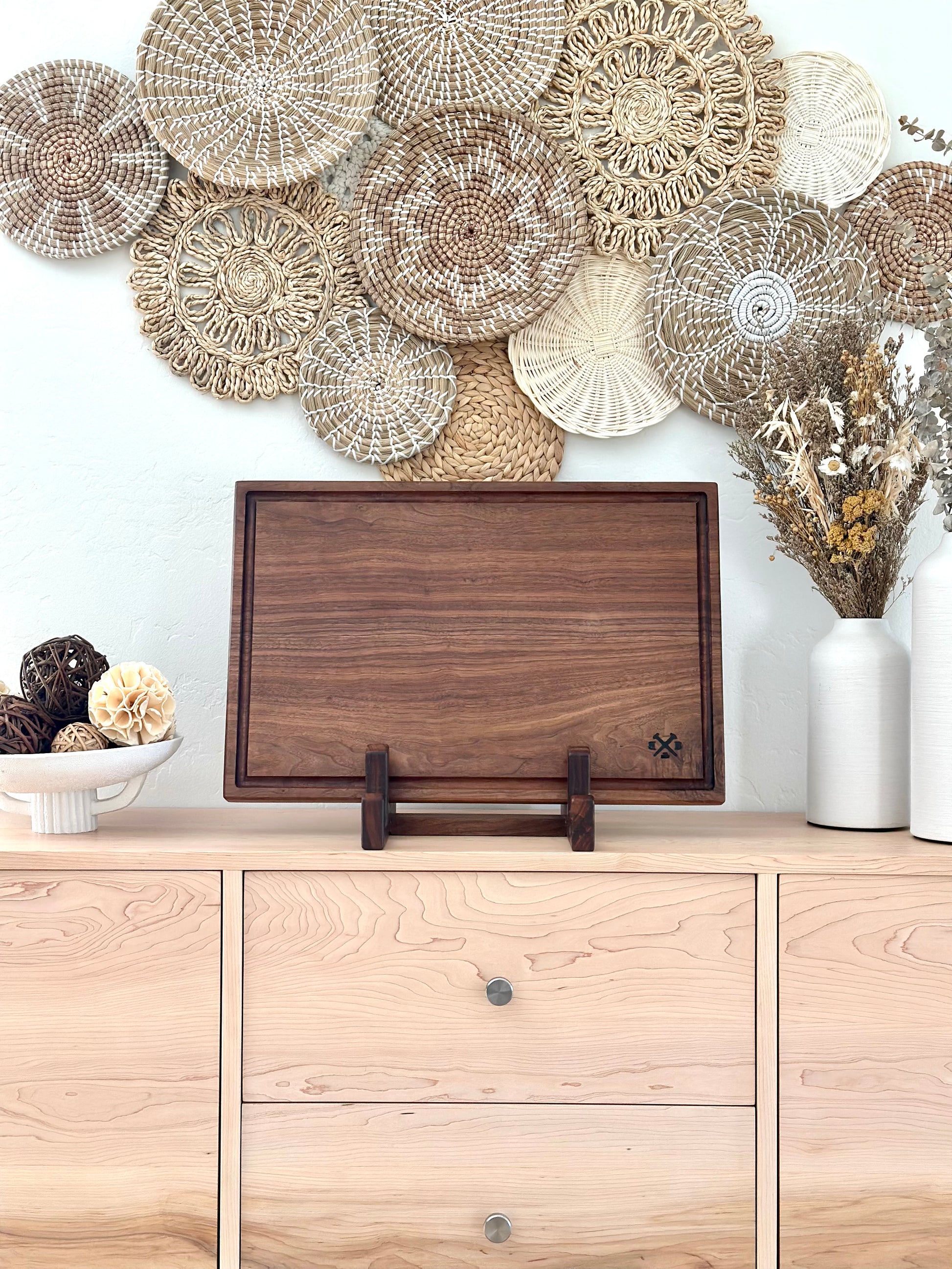 Bonobuilt walnut cutting board No. 004 Lite, 23×15 in, slim profile with juice groove, displayed upright in a stand — handcrafted in Visalia, California
